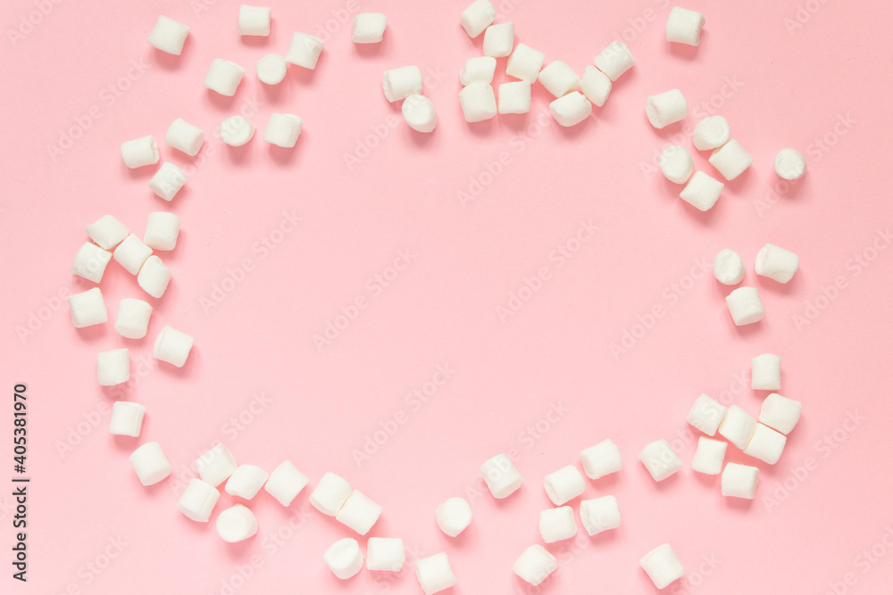 Marshmallow frame on a pink background. Concept of love, happy valentine's day, women's day and birthday celebration. Flatly, copy space, mock up, banner.