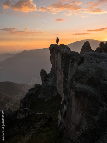 Sunset panorama hiker poncho on Marcahuasi andes plateau rock formations mountain hill valley nature landscape Lima Peru photo