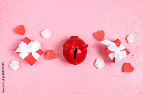 Piggy bank with gifts, candles hearts and roses on pink background.