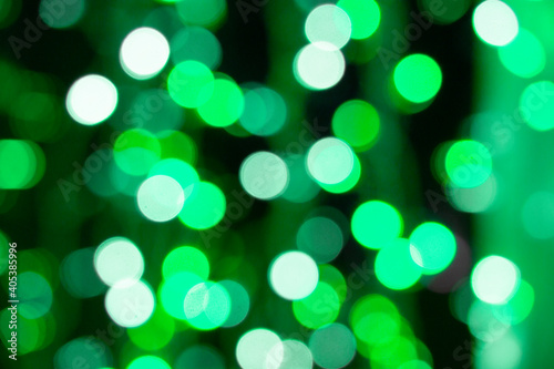 Abstract green bokeh texture on black background