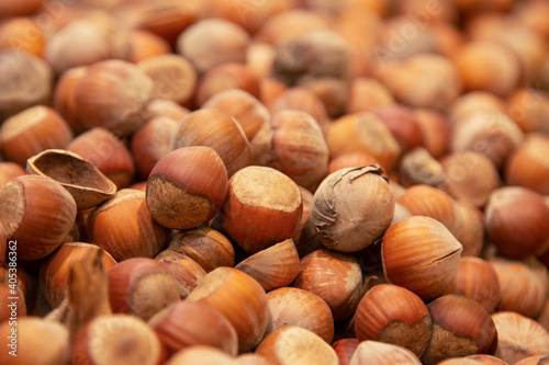 Forest nut background. Full and half of hazelnuts on white background top view. Isolated
