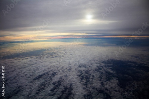 spectacular sunset seen from an airplane with clouds in the foreground and in the distance 