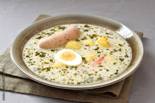 Polish soup zurek  with egg and sausage.