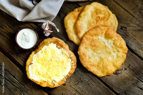 Hungarian street food - langos.  Flatbread with sour cream-garlic sauce and cheese