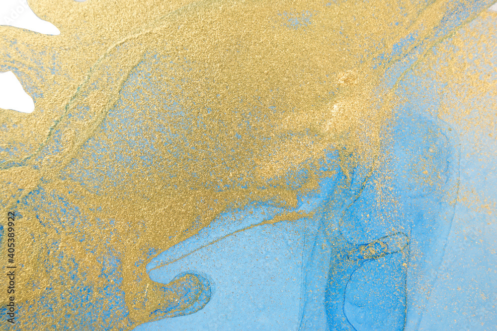 Blue and gold ink drops mixed with gold powder.