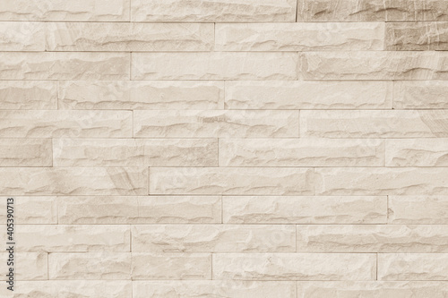 Empty background of wide cream brick wall texture. Beige old brown brick wall concrete or stone textured  wallpaper limestone abstract flooring Grid uneven interior rock. Home decor design backdrop.
