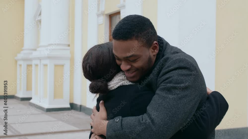 Happy african american man and woman hugging, meeting unexpectedly outdoors, slow motion Happy african american man and woman hugging, meeting unexpectedly outdoors, slow motion
