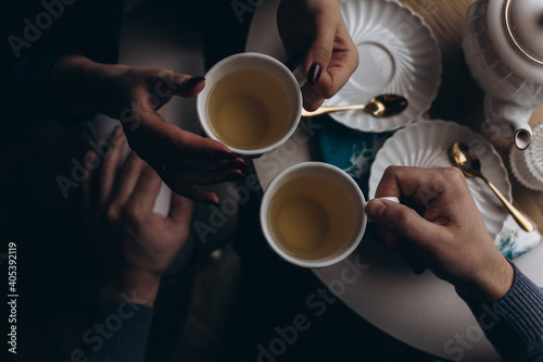 Hands of loving couple. Romantic breakfast in cafe. Tea ceremony in cafe