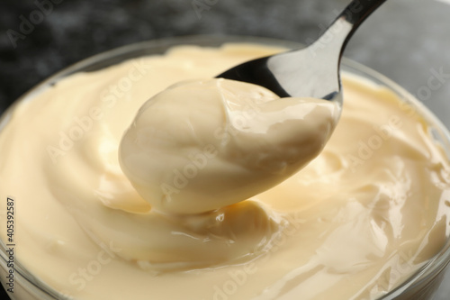 Bowl and spoon with mayonnaise, close up