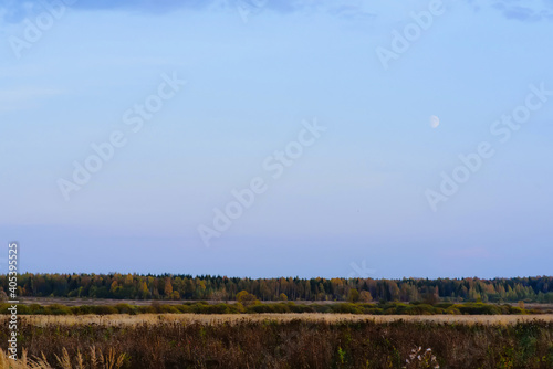 autumn evening landscape in a field with sky and moon