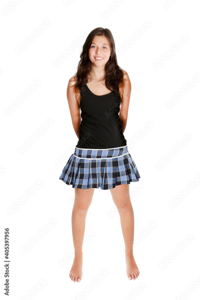 Full length portrait of a beautiful young woman wearing a black top and a blue miniskirt, isolated on white studio background Full length portrait of a beautiful young woman wearing a black top and a blue miniskirt, isolated on white studio background