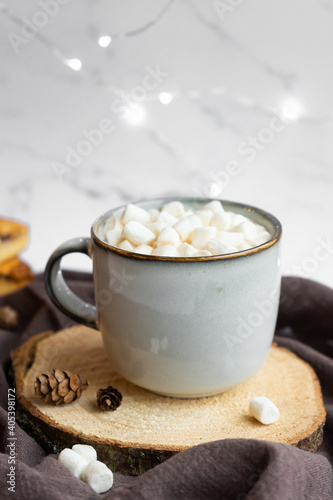 Hot cocoa with marshmallows. Rustic style, wooden stand.