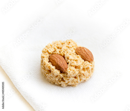 Obraz na płótnie Very soft, creamy sweet candy with almonds on a light textile background w salonie