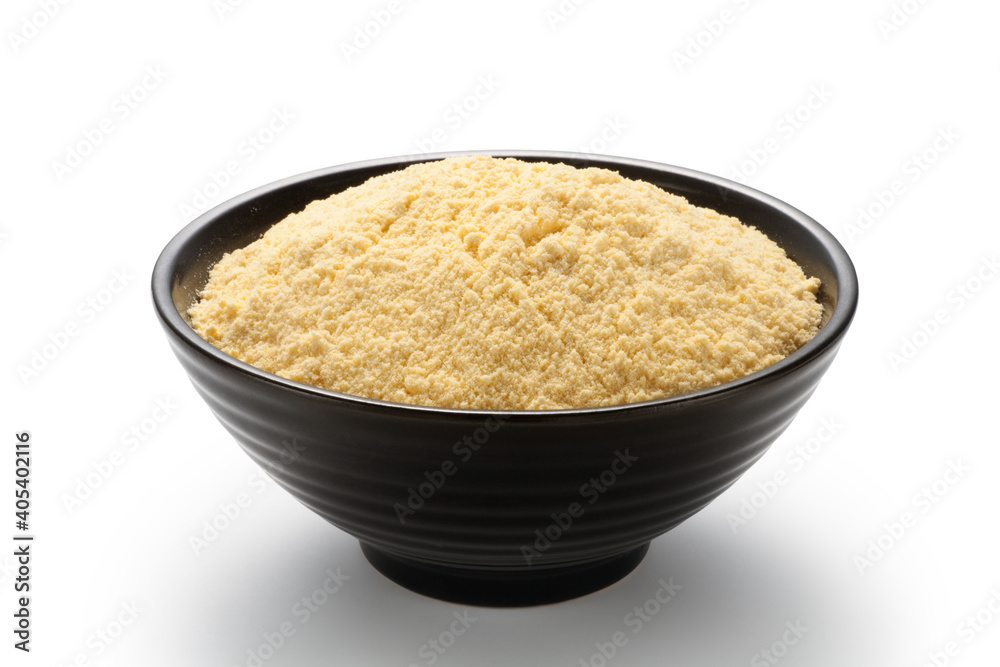 Corn flour in a black bowl isolated on white background Corn flour in a black bowl isolated on white background