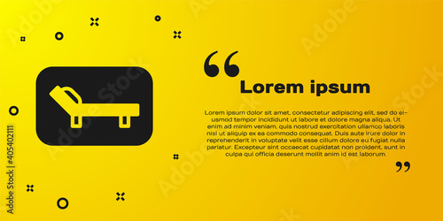 Black Sunbed icon isolated on yellow background. Sun lounger. Vector.