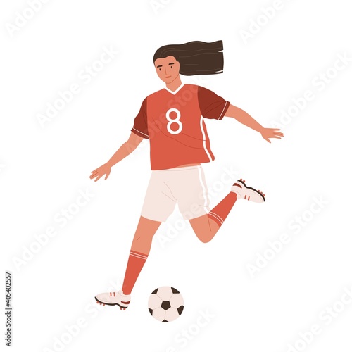 Young female soccer player running and kicking ball forward. Woman playing Eu...