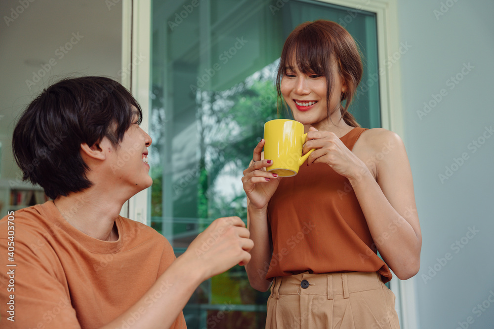 Happy asian couple family. Beautiful wife bring a cup of hot coffee to husband who work from home. Happy asian couple family. Beautiful wife bring a cup of hot coffee to husband who work from home.