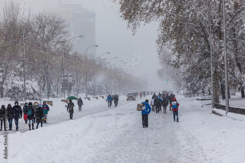 people enjoying the streets of snow, in the city of Madrid, covered by the storm philomena