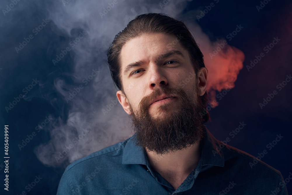 Emotional man black shirt attractive look close-up smoke in the background Emotional man black shirt attractive look close-up smoke in the background
