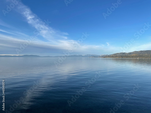 Landscape view of clouds reflected in the calm blue waters of Lake Tahoe