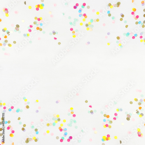 Party colorful confetti over white wooden background . Top view  flat lay