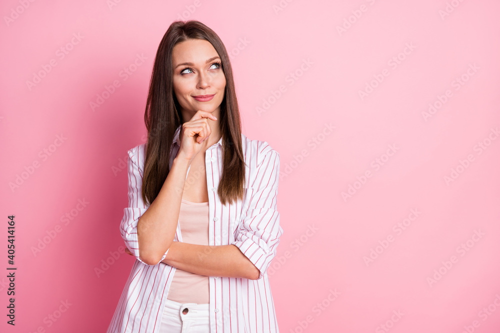 Photo of young beautiful curious dreamy girl woman thinking look in copyspace hold hand on chin isolated on pink color background