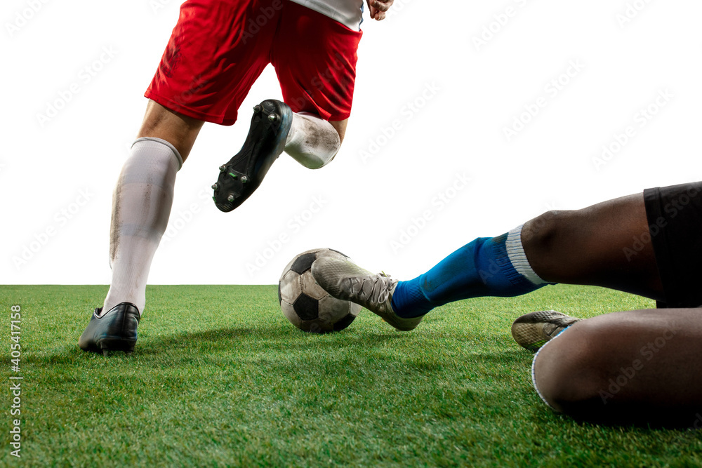Close up legs of professional soccer, football players fighting for ball on field isolated on white background. Concept of action, motion, high tensioned emotion during game. Cropped image. Close up legs of professional soccer, football players fighting for ball on field isolated on white background. Concept of action, motion, high tensioned emotion during game. Cropped image.