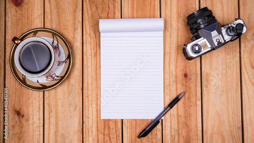 blank white paper notes with coffee and old camera on top wood table