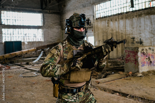 Special forces soldier doing tactical training in building clearing (CQB). He is wearing multicam uniform and assault rifle HK416.