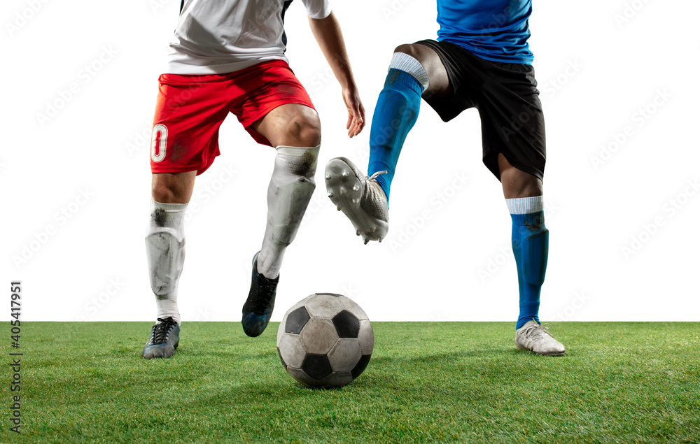 Close up legs of professional soccer, football players fighting for ball on field isolated on white background. Concept of action, motion, high tensioned emotion during game. Cropped image.