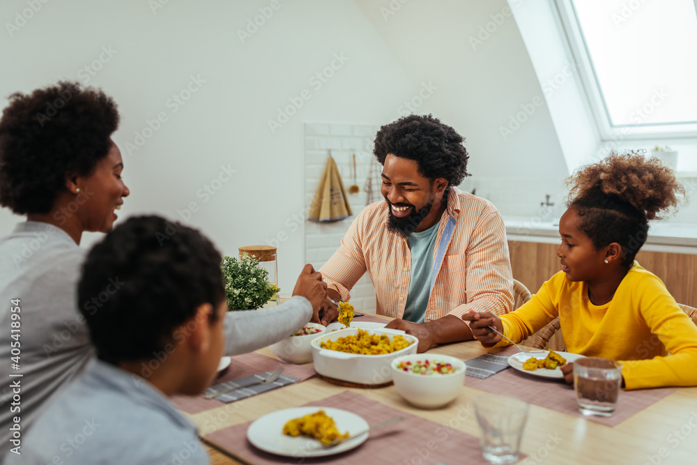 Cute afro family having lunch together at home