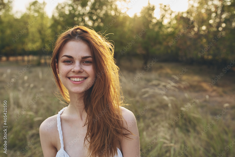 attractive woman in a white sundress resting in nature at sunset attractive woman in a white sundress resting in nature at sunset