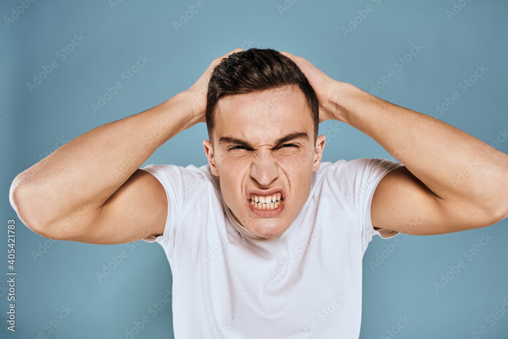 Man gestures with his hands emotions white t-shirt expression blue background Man gestures with his hands emotions white t-shirt expression blue background