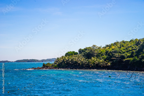 Hon Thom island in Phu Quoc, Vietnam, Asia - Tropical view with colorful houses, blue waves and blue sky, fishing boats and far away is a longest cable car