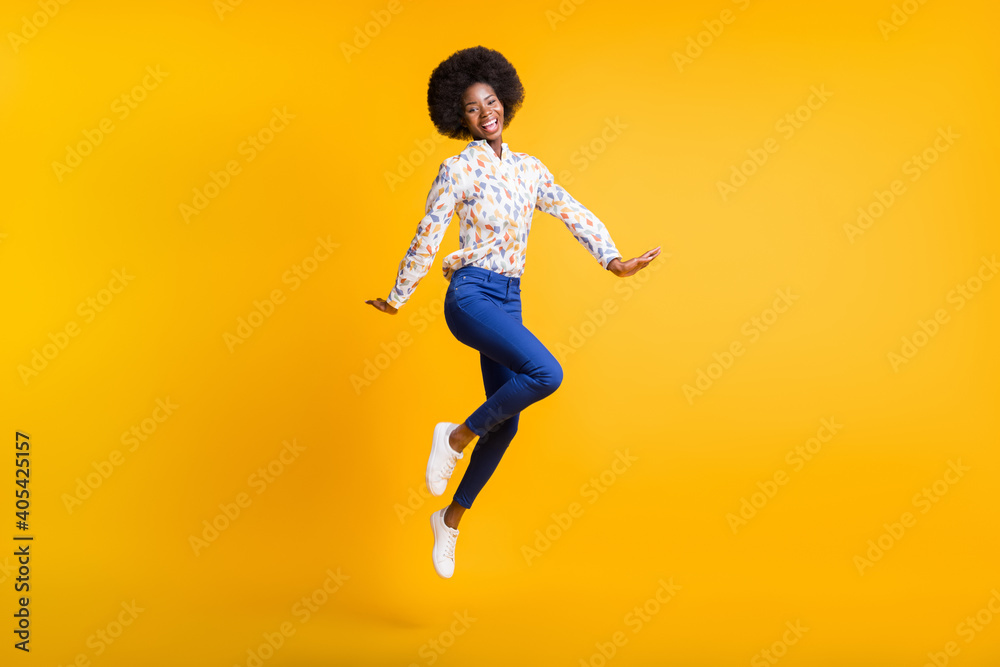Full length photo of shiny pretty dark skin lady dressed casual outfit jumping high isolated yellow color background