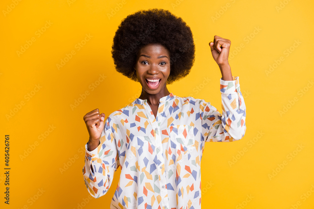 Portrait of astonished person fists up open mouth celebrate isolated on vivid yellow color background Portrait of astonished person fists up open mouth celebrate isolated on vivid yellow color background