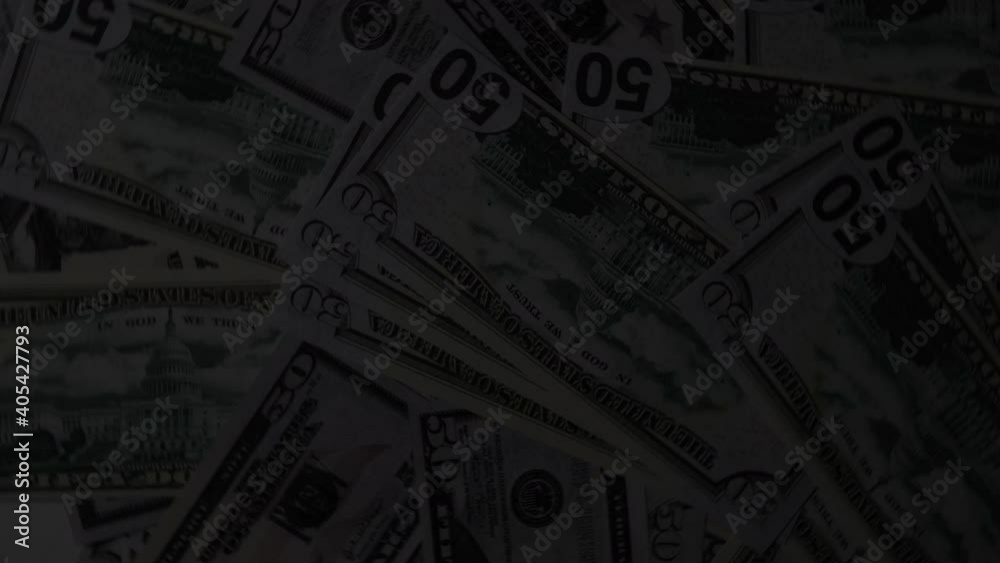 Rotating table strewn with dollars in light of police flashing lights Rotating table strewn with dollars in light of police flashing lights