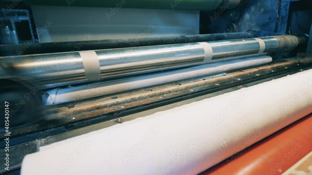 Working paper roll cutting machine at a paper factory