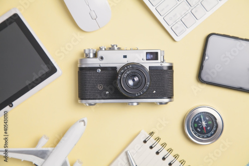 Compass, camera and other objects on the yellow background. Travel