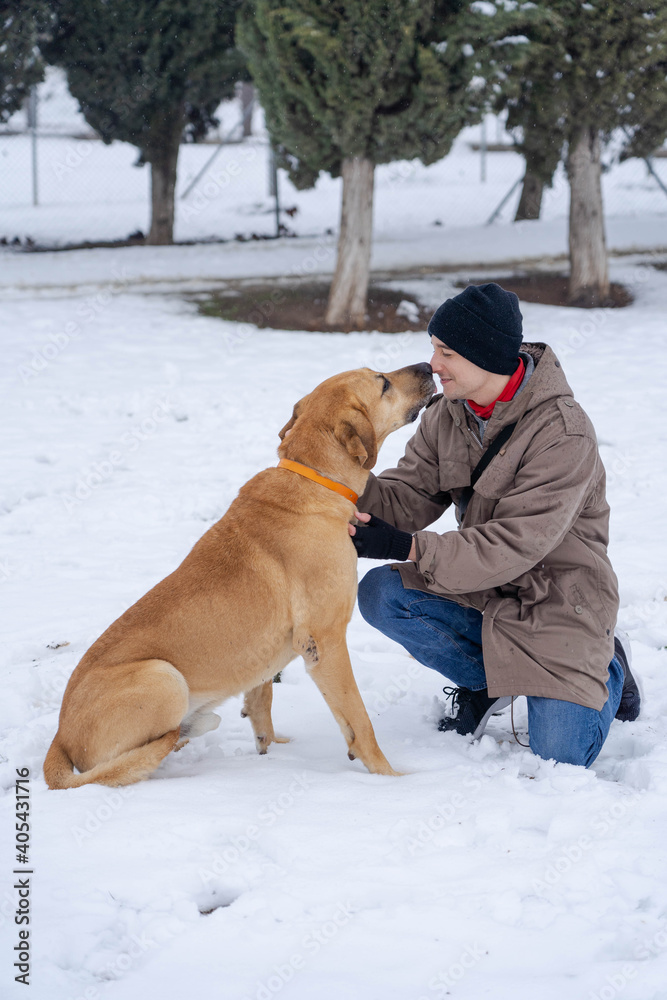 Boy with his dog in the snow