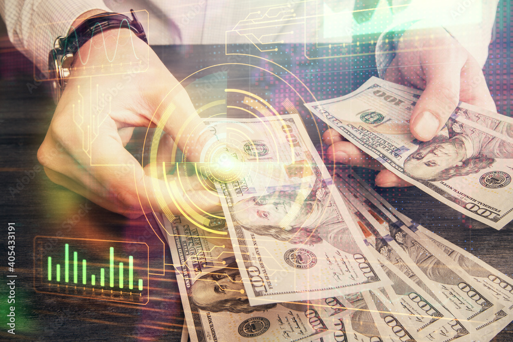 Double exposure of technology drawing hologram and us dollars bills and man hands. Data concept Double exposure of technology drawing hologram and us dollars bills and man hands. Data concept