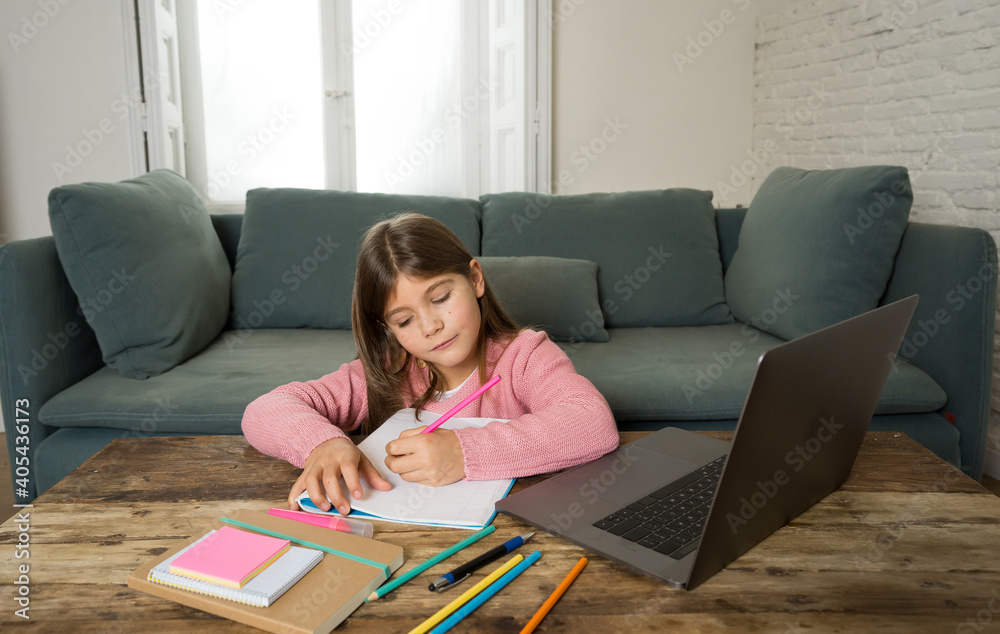 School girl with laptop studying online at home as school is closed due to new COVID-19 Lockdown School girl with laptop studying online at home as school is closed due to new COVID-19 Lockdown