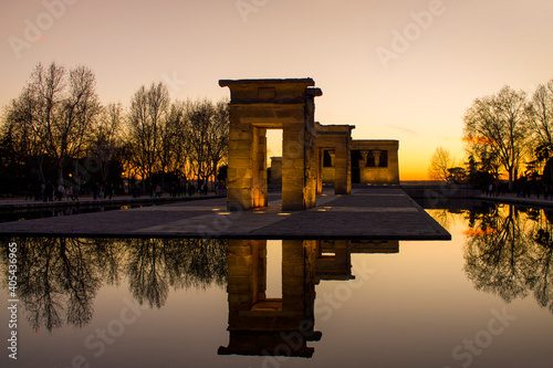 Sunset at the Egyptian Temple of Debod forming a symmetrical reflection in the water. Madrid, Spain.