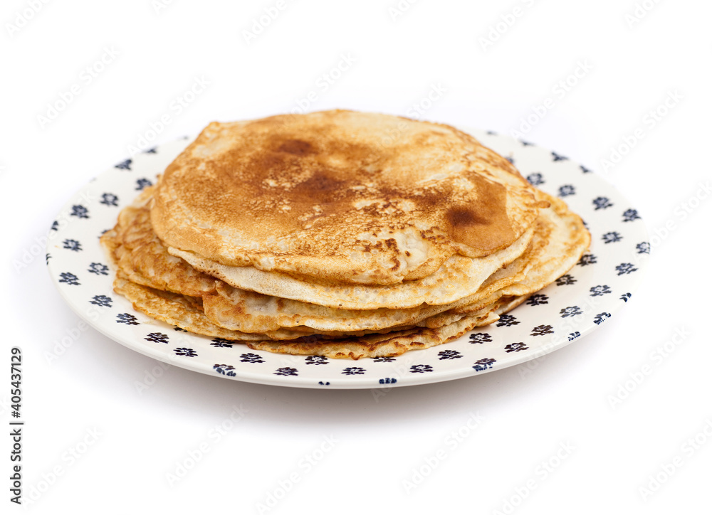 Stack of freshly made pancakes, served on a plate with blue pattern. Studio photo isolated on white background. Stack of freshly made pancakes, served on a plate with blue pattern. Studio photo isolated on white background.