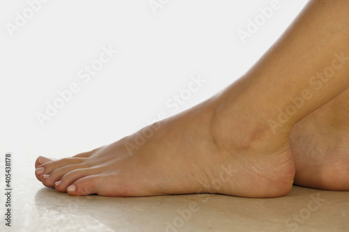 Perfect pedicured. Female feet on marble. Close-up view of a beautiful pedicure. Beautiful leg side view