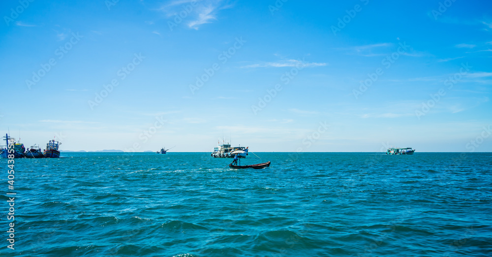 Hon Thom island in Phu Quoc, Vietnam, Asia - Tropical view with colorful houses, blue waves and blue sky, fishing boats and far away is a longest cable car Hon Thom island in Phu Quoc, Vietnam, Asia - Tropical view with colorful houses, blue waves and blue sky, fishing boats and far away is a longest cable car