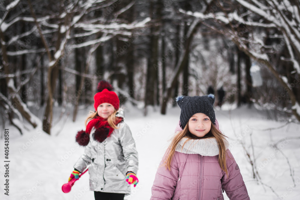 Two little girls playing in the winter