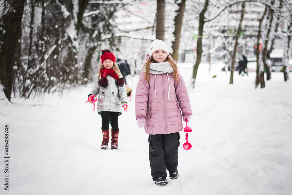 Two little girls playing in the winter Two little girls playing in the winter