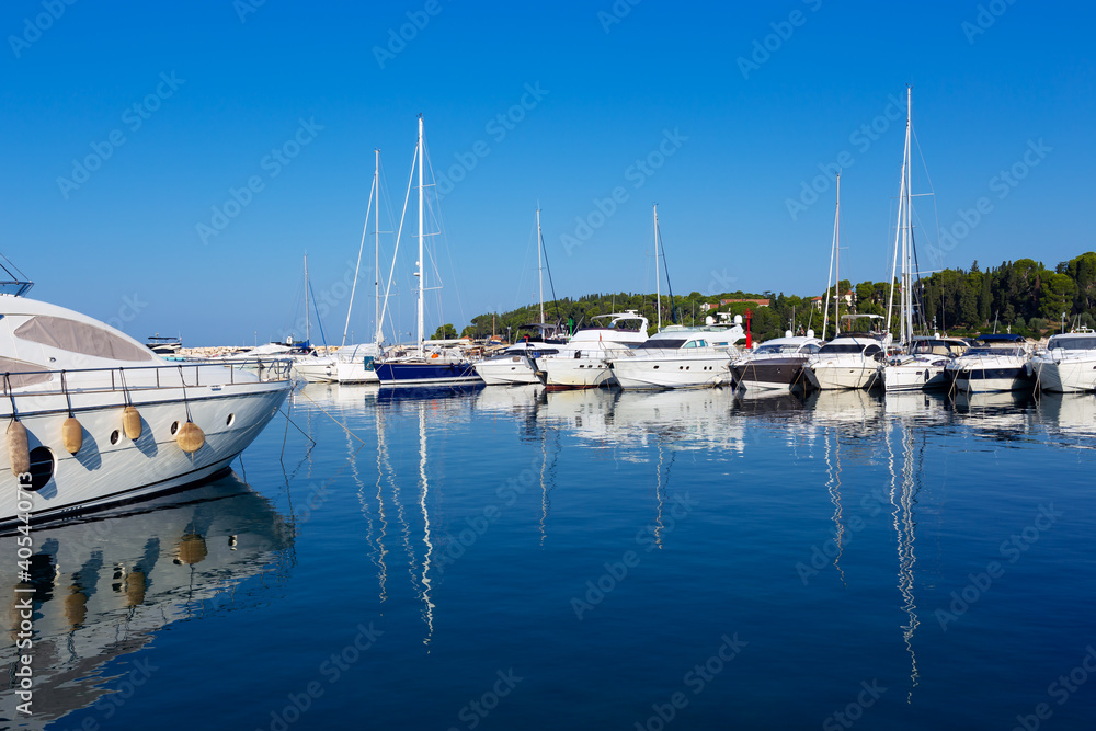 sailboats moored at the pier in harbour of Rovinj town, Croatia.