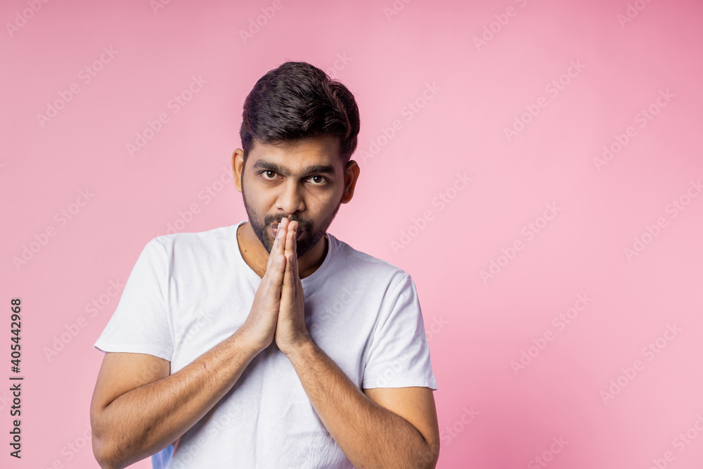 Portrait of handsome Indian guy standing on pink background Portrait of handsome Indian guy standing on pink background